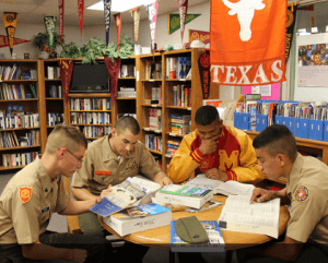 Cadets at the Marine Military Academy look over college research literature in the school's college room.