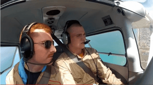 An instructor and student pilot perform a turn above the South-Texas shore line.
