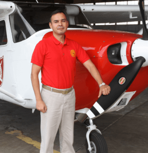 Mr. Mitri Garib standing beside a Redhawk 172 flight training aircraft.