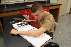 A military school student studying STEM related lessons in physics class.