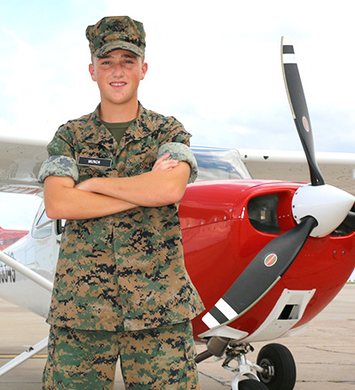 MMA aerospace cadet standing next to a Redbird Cessna