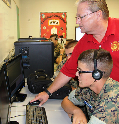 Teacher and military school student in a computer lab