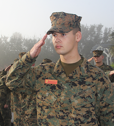 Military school cadet saluting
