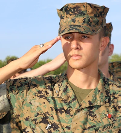 MMA Cadet in formation saluting
