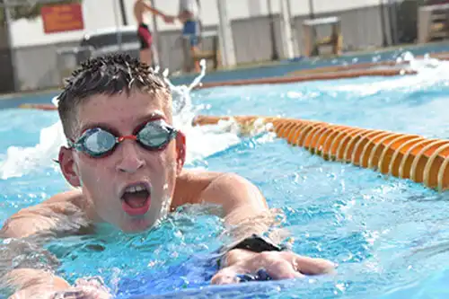 a student in varsity swimming